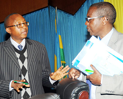 The Auditor General Obadiah Biraro( L) chatting with Deputy Speaker of Evariste Kalisa, at Parliament last Friday. The New Times / John Mbanda.