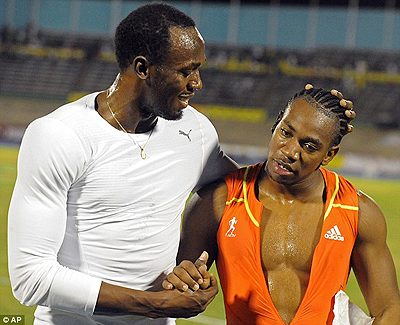 Bolt congratulates Blake after the race. Net photo.