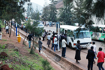 Passengers waiting for taxis at a Kigali bus stop. The New Times / File.