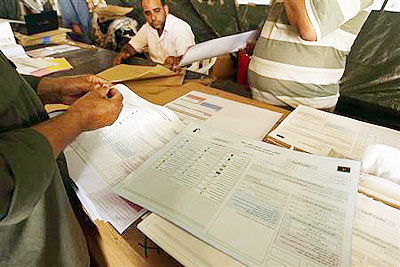 Election commission workers prepare voting forms to be distributed to polling stations.  Net photo.