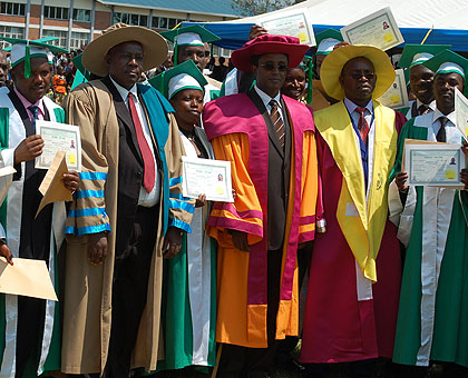 Education Minister Dr Vincent Biruta (C) and leaders of INES pose for a photo with the graduands. The New Times / S. Nkurunziza.