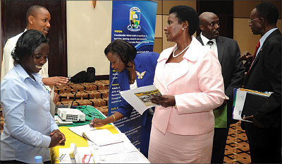 Uganda's Ministers of Trade and Education,  Amelia Kyambadde (C) Jessica Alupo (L), respectively,  tour University stands at Serena Hotel. The New Times / John Mbanda.