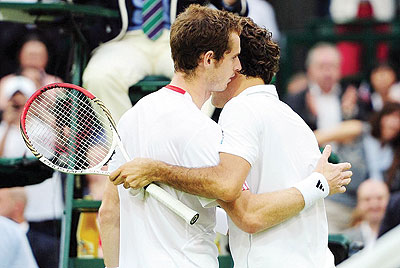 Andy Murray congratulates Roger Federer on his record seventh Wimbledon singles title. Net photo.