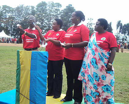 MP Theobald Mporanyi (L) and other Members of Parliament demonstrating how a condom is used during a past public event. The New Times, File