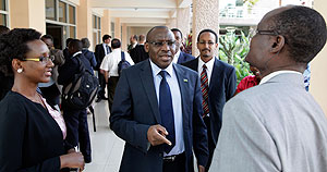 Rwandau2019s central bank Governor Claver Gatete ( C ) chats with other participants during the break. The New Times / Timothy Kisambira. 