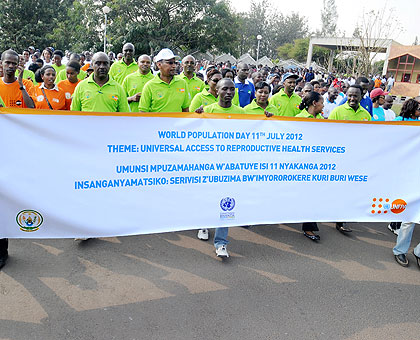 Finance minister John Rwangombwa (in cap) and other officials join the youth in a march to mark World Population Day in Kigali yesterday. The New Times / John Mbanda.