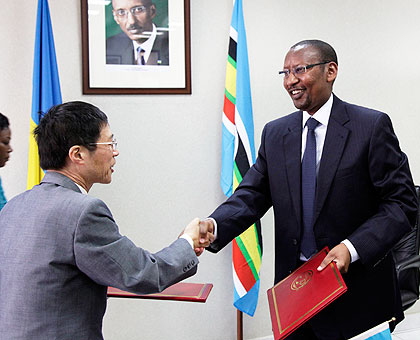 Finance Minister John Rwangombwa (R) exchanging documents with Shu Zhan the Ambassador of China, yesterday. The new Times Timothy Kisambira