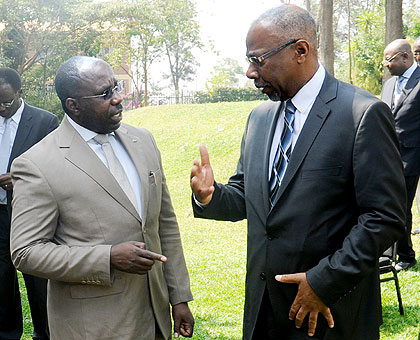 Prime Minister Pierre Damien Habumuremyi (L) chats with Commonwealth Deputy Secretary-General Ransford Smith yesterday. The New Times / John Mbanda.