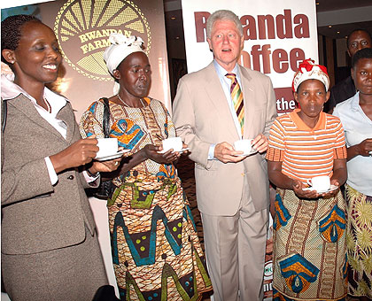 Former US President Bill Clinton, with Rwandan coffee growers, during a past visit to the country. Left is the Agriculture Minister Dr Agnes Kalibata. The New Times / File.