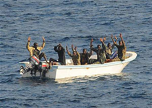 Suspected pirates keep their hands in the air as they are being apprehended by the U.S. Net Photo.