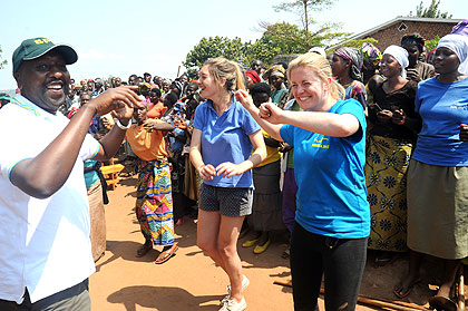 Members of Project Umubano dance with residents of Bumbogo in Gasabo District after a recent Umuganda exercise. The New Times / John Mbanda.