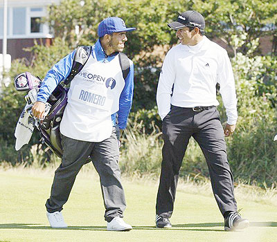 Carlos Tevez (left) and Andres Romero share a joke on day four of the 2012 British Open. Net photo.