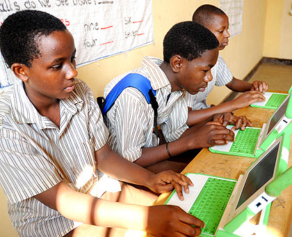 Pupils of GS Kicukiro concentrate on their laptops. The New Times / John Mbanda.