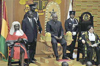 Ghanas Vice-President John Dramani Mahama (C) sits after taking the oath of office as head of state, hours after the announcement of the death of Ghanas President John Atta Mills. Net photo.