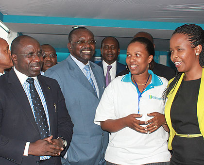 Prime Minister Pierre Damien Habumuremyi  (L) accompanied by Trade and Industry Minister Francois Kanimba (2nd L) and other officials admire at the ongoing Expo yesterday. The New Times / John Mbanda.