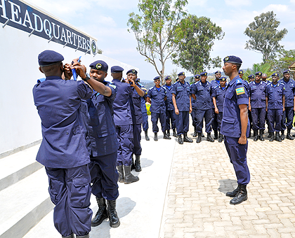 The police trainees who received new peeps decorate each other as senior police officers look on. The New Times courtesy