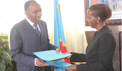 Foreign Affairs Minister Louise Mushikiwabo (R) with Congolese Minister for International and Regional Cooperation, Raymond Tshibanda,  exchange documents after talks in Kinshasa recently. The NewTimes.