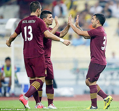 Tevez (right) and Aguero celebrate as Alexander Kolarov joins the party. Net photo.