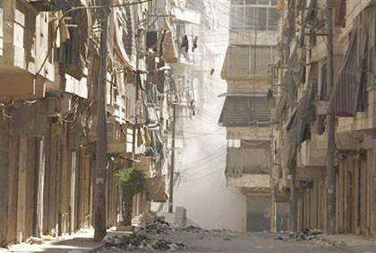 Smoke rises between buildings after shelling by forces loyal to President Bashar Al-Assad in Aleppos district of Salah Edinne .Net photo.