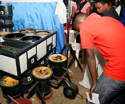 Showgoers admire one of the environmentally friendly stoves displayed at the ongoing expo.  The New Times / John Mbanda.