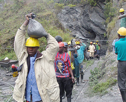 Miners of Wolfram in Northern Province ferry minerals from a mine. The New Times / File.