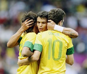 Thiago Silva (centre) congratulates Oscar after he scored the team's third goal against Belarus. Brazil will take on Mexico in the finals on Saturday. Net photo.