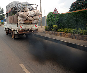 A truck lets off dark exhaust fumes common among old vehicles. The New Times / John Mbanda.