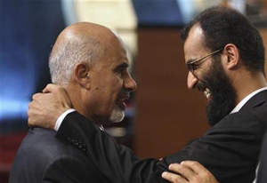 Mohammed Magarief (L) is congratulated after being picked as Libyau2019s president after officers sorted the voting results for the selection of the National Congress president. Net photo.