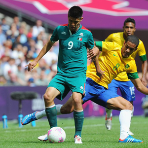 Two goal hero Oribe Peralta of Mexico (L) is challenged by Romulo of Brazil during the Men's Football Final. Net photo.