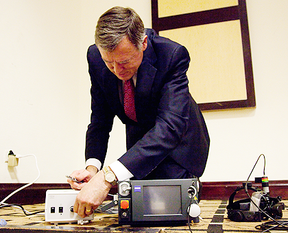 Mathew A. Thomas, professor of Clinical Opthalmology from Washington University, fixing a laser machine. The New Times / Timothy Kisambira. country. 