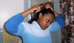 A woman  oiling her hair. Net photo.