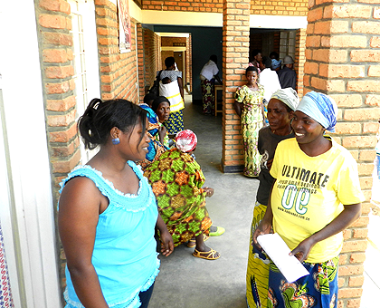 Francoise Niyikama (L), a health facilitator in Mayange, talking to women before screening them.  The New Times / S. Rwembeho.