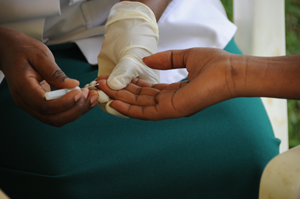 A volunteer takes an AIDS test.  The New Times / Timothy Kisambira.