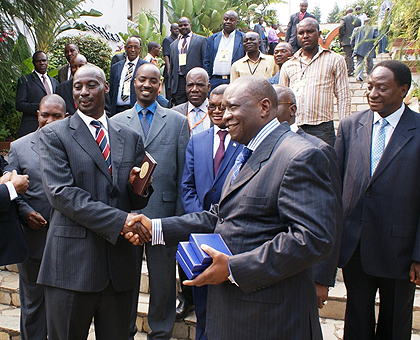 Ugandau2019s Chief of Defence Forces  Gen. Aronda Nyakairima exchanging gifts with his counterpart from Congo Brazzaville Gen. Charles Richard Mondjo. Looking on is  Rwanda Defence Forces Chief of Defence Staff Lt. Gen. Charles Kayonga (C) and other delegates