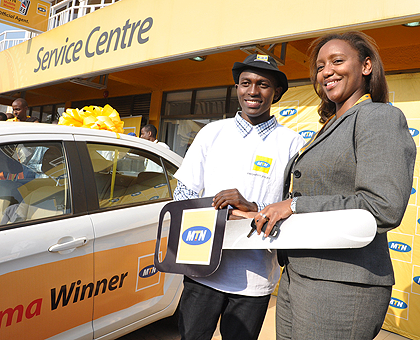 MTN`s Chief Marketing Officer, Yvonne Manzi Makolo, handing over the car key to Savio Uwamukiza, the winner of the first Sharama draw. 