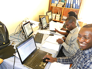 Benjamin Rukundo (R) in charge of Data entry service at Mayange Health Centre.  The Sunday Times / S. Rwembeho.