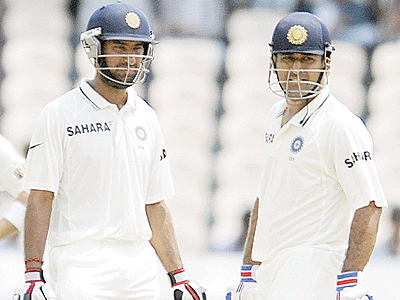 Pujara (L) and Dhoni (R) put on 127 for the sixth wicket. Net photo.