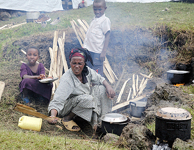 A mother cooks for her family in Nkamira camp. The New Times / File.