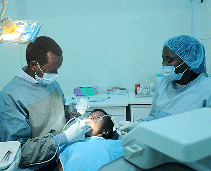 A dentist at Kigali Health Institute (KHI) attends to a patient. The New Times / John Mbanda.