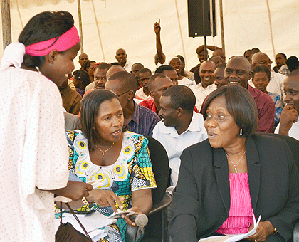 State Min. Alvera Mukabaramba (R) and Governor Odette Uwamariya (L) consult during the fundraising ceremony. The New Times/S. Rwembeho.