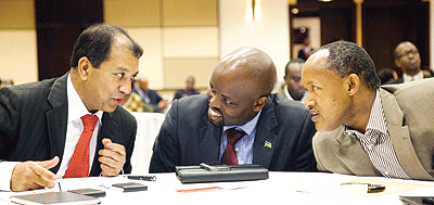 Minister Jean Philbert Nsengmana (C), together with Faustin Mbundu of PSF (R), listen to Manoj Boolakee, the CEO of Connexions at the launch. The New Times/Timothy Kisambira.