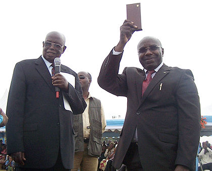 PM Habumuremyi (R) receives a bible from Pastor Uzziel Ruhaya, the INILAK's legal representative, on Thursday, during the event. The New Times / JP Bucyensenge.