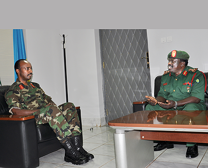 Lt Gen Charles Kayonga (left) during his talks with the Tanzanian head of delegation Brig. Gen. Ezekiel Elias Kyunga. The New Times / John Mbanda.