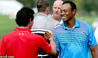 Woods (R) and McIlroy enjoy each others' company on the golf course. Net photo.