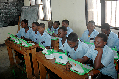 Primary school pupils using laptops. The New Times / File.