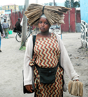 A young woman carries paper bags. The New Times / File.