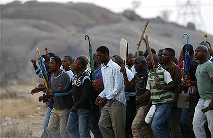 Striking mineworkers dance as they leave a report-back meeting on negotiations at a mine in South Africas North West Province.  Net photo.