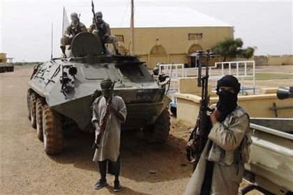 Fighters from the Al Qaeda-linked Islamist group MUJWA, who are travelling with a convoy including Burkina Faso foreign minister Djibril Bassole, stand guard in Gao, northern Mali. Net photo.