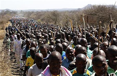 Mine workers take part in a march at Lonminu2019s Marikana mine in South Africau2019s North West Province. Net photo.