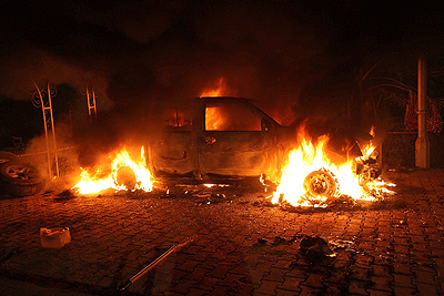 A car engulfed in flames after being set on fire inside the US consulate compound in Benghazi yesterday. AFP